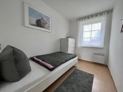 Ein Bett oder Betten in einem Zimmer der Unterkunft Ferienwohnung Nordseenest