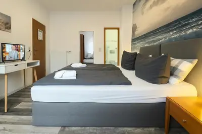 Ein Bett oder Betten in einem Zimmer der Unterkunft City Center Hotel Garni Cuxhaven