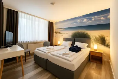 Ein Bett oder Betten in einem Zimmer der Unterkunft City Center Hotel Garni Cuxhaven