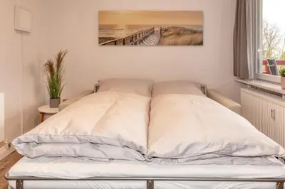 Ein Bett oder Betten in einem Zimmer der Unterkunft Terrassenhaus, FeWo 45