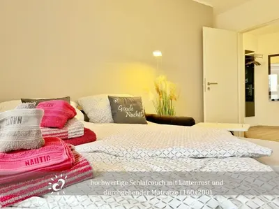 Ein Bett oder Betten in einem Zimmer der Unterkunft Ferienwohnung de Kattuul direkt am Nordseedeich