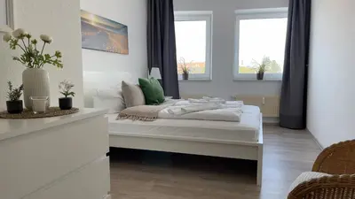 Ein Bett oder Betten in einem Zimmer der Unterkunft Haus Nordseebrandung FeWo D1 4