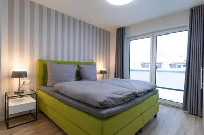 Ein Bett oder Betten in einem Zimmer der Unterkunft Dorumer Sielhuus 19