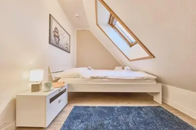Ein Bett oder Betten in einem Zimmer der Unterkunft Stranddüne - 12