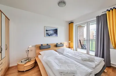 Ein Bett oder Betten in einem Zimmer der Unterkunft Strandpalais - C3