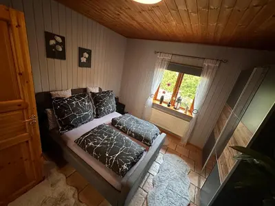 Ein Bett oder Betten in einem Zimmer der Unterkunft Apartment Holzhaus