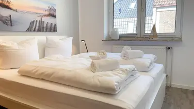 Ein Bett oder Betten in einem Zimmer der Unterkunft Nige Ooge FeWo 7