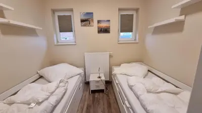 Ein Bett oder Betten in einem Zimmer der Unterkunft Ferienhaus Strandengel