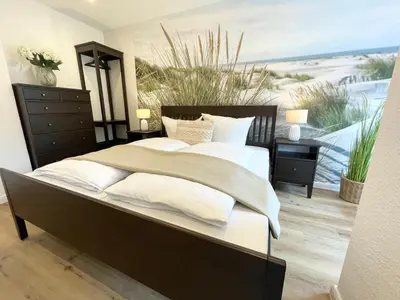 Ein Bett oder Betten in einem Zimmer der Unterkunft Haus Nordseebrandung FeWo 7