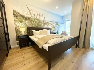 Ein Bett oder Betten in einem Zimmer der Unterkunft Haus Nordseebrandung FeWo 7