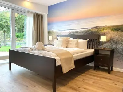Ein Bett oder Betten in einem Zimmer der Unterkunft Haus Nordseebrandung FeWo 8