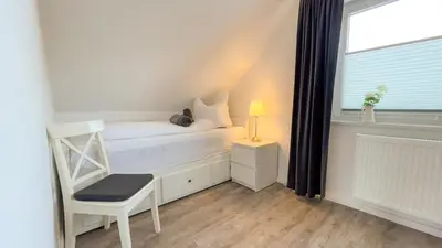Ein Bett oder Betten in einem Zimmer der Unterkunft Watt´n Traum Wohnung 2