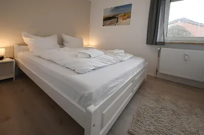 Ein Bett oder Betten in einem Zimmer der Unterkunft Nordseestube