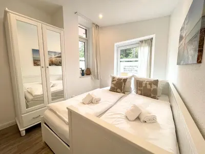 Ein Bett oder Betten in einem Zimmer der Unterkunft Haus Nordseebrandung FeWo 3