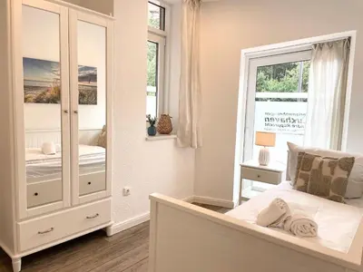 Ein Bett oder Betten in einem Zimmer der Unterkunft Haus Nordseebrandung FeWo 3