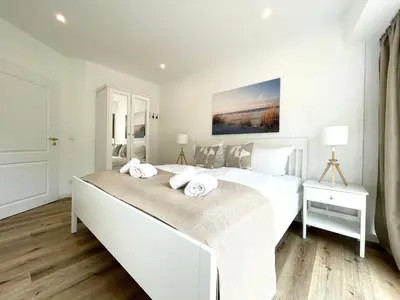 Ein Bett oder Betten in einem Zimmer der Unterkunft Haus Nordseebrandung FeWo 5