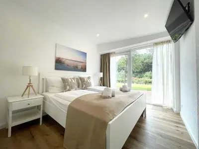 Ein Bett oder Betten in einem Zimmer der Unterkunft Haus Nordseebrandung FeWo 5