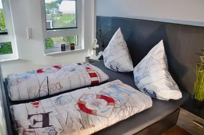 Ein Bett oder Betten in einem Zimmer der Unterkunft Meeresleuchten Duhnen-Entrée 8