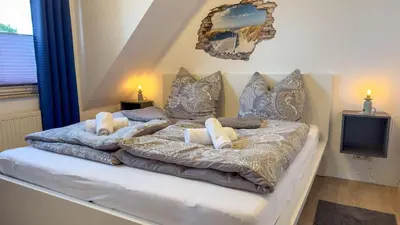 Ein Bett oder Betten in einem Zimmer der Unterkunft Haus Nordseeperle 11
