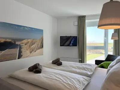 Ein Bett oder Betten in einem Zimmer der Unterkunft Ferienwohnung de Roggenbloom