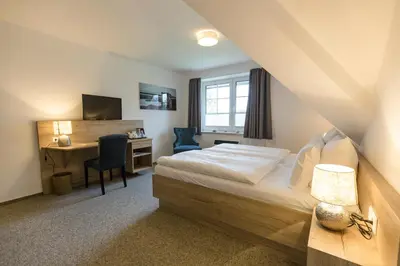 Ein Bett oder Betten in einem Zimmer der Unterkunft Cuxlandhotel Studio 124