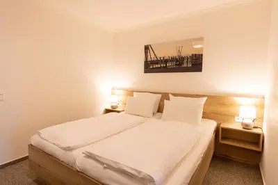 Ein Bett oder Betten in einem Zimmer der Unterkunft Cuxlandhotel Studio 121