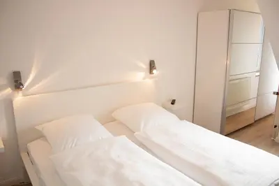 Ein Bett oder Betten in einem Zimmer der Unterkunft Ferienwohnung Sieltrift 4-01
