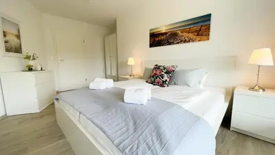 Ein Bett oder Betten in einem Zimmer der Unterkunft Haus Nordseebrandung FeWo B2 3