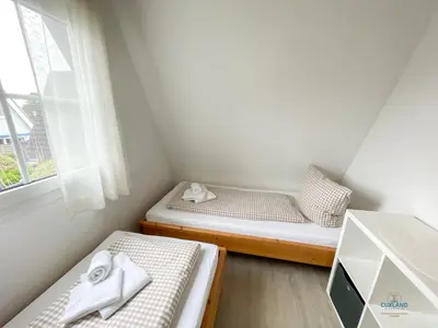 Ein Bett oder Betten in einem Zimmer der Unterkunft Ferienhaus Am Ringwall 36