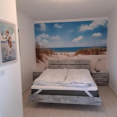 Ein Bett oder Betten in einem Zimmer der Unterkunft Perlebucht-Oase