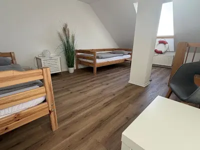 Ein Bett oder Betten in einem Zimmer der Unterkunft Dat Stürboord - Nordseeblick, Pool & Sauna