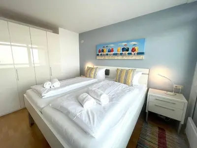 Ein Bett oder Betten in einem Zimmer der Unterkunft Frische Brise FeWo 12.06