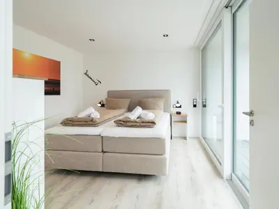 Ein Bett oder Betten in einem Zimmer der Unterkunft Inseltörn Wohnung 6