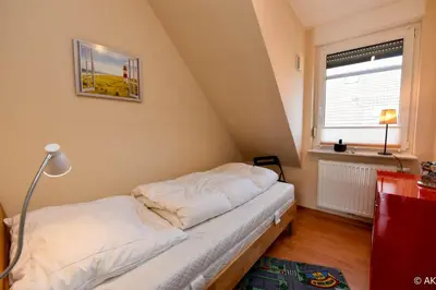 Ein Bett oder Betten in einem Zimmer der Unterkunft Frische Duhner Brise