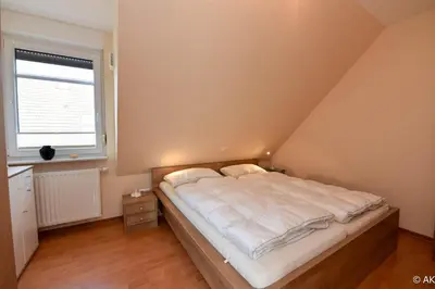 Ein Bett oder Betten in einem Zimmer der Unterkunft Frische Duhner Brise