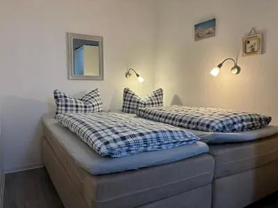 Ein Bett oder Betten in einem Zimmer der Unterkunft Haus Pavillon, Ferienwohnung 13