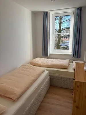 Ein Bett oder Betten in einem Zimmer der Unterkunft Haus Hohe Worth, Apartment 112
