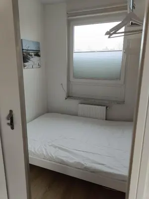 Ein Bett oder Betten in einem Zimmer der Unterkunft Küstenhaus Duhnen - Ferienhaus mit Meerblick
