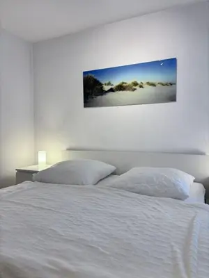 Ein Bett oder Betten in einem Zimmer der Unterkunft Haus Poseidon, Apartment POS04