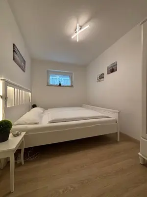 Ein Bett oder Betten in einem Zimmer der Unterkunft Haus Poseidon, Apartment POS03