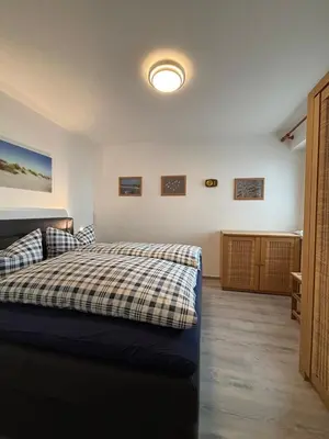 Ein Bett oder Betten in einem Zimmer der Unterkunft Haus Poseidon, Apartment POS34