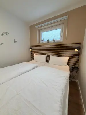 Ein Bett oder Betten in einem Zimmer der Unterkunft Haus Poseidon, Ferienwohnung POS33