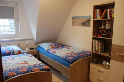 Ein Bett oder Betten in einem Zimmer der Unterkunft Ferienhaus Alter Duhner Weg