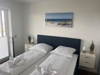 Ein Bett oder Betten in einem Zimmer der Unterkunft Duhner Spitze Wohnung 12