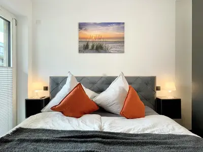 Ein Bett oder Betten in einem Zimmer der Unterkunft Duhner Spitze FEWO44