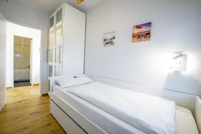 Ein Bett oder Betten in einem Zimmer der Unterkunft Strandhochhaus SHC5