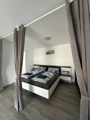 Ein Bett oder Betten in einem Zimmer der Unterkunft Star Ferien Appartement