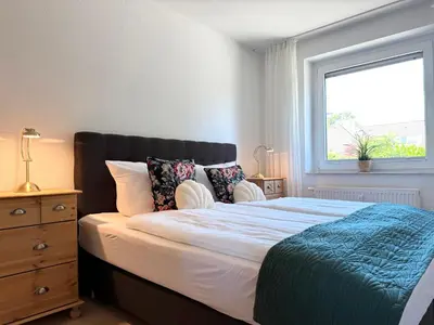 Ein Bett oder Betten in einem Zimmer der Unterkunft FeWo 1