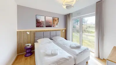 Ein Bett oder Betten in einem Zimmer der Unterkunft Lighthouse Duhner Spitze - W02