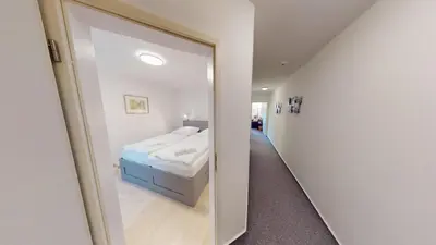 Ein Bett oder Betten in einem Zimmer der Unterkunft Stranddüne - 5